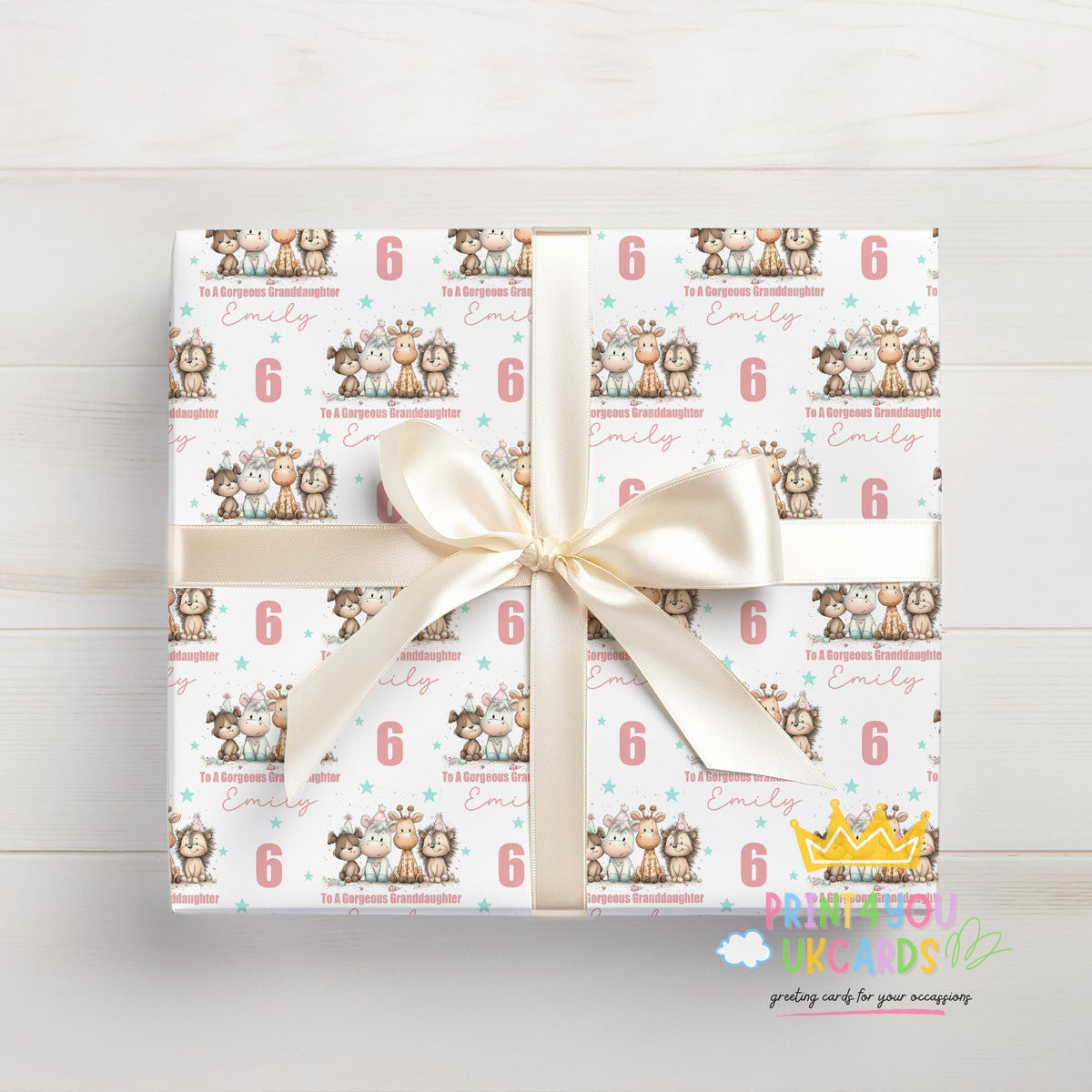 Birthday gift wrapped in the personalised animal wrapping paper, tied with a white ribbon and featuring the number 6