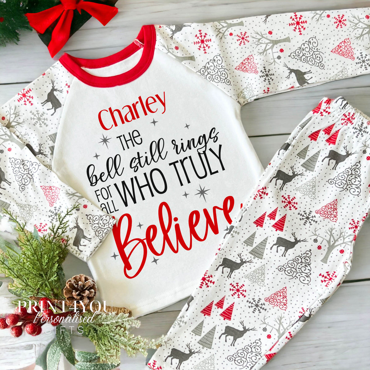 Child wearing personalised reindeer print Christmas pyjamas with Believe design, size 2-3 years