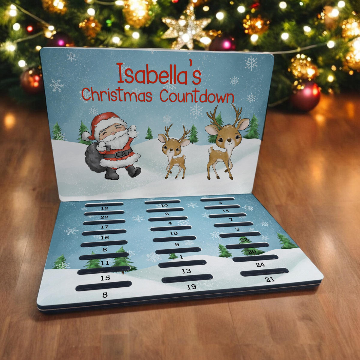 Personalised A5 MDF Christmas advent calendar with a Santa and baby reindeer design and 24 numbered coin slots, personalised as Isabella's Christmas Countdown