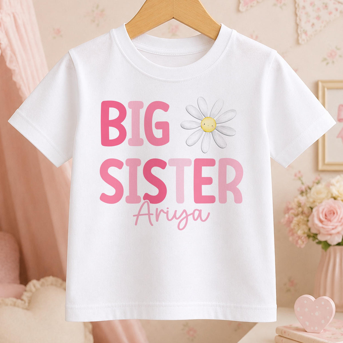Personalised Big Sister t-shirt – white tee with pink BIG SISTER lettering, a daisy and the name Ariya in script