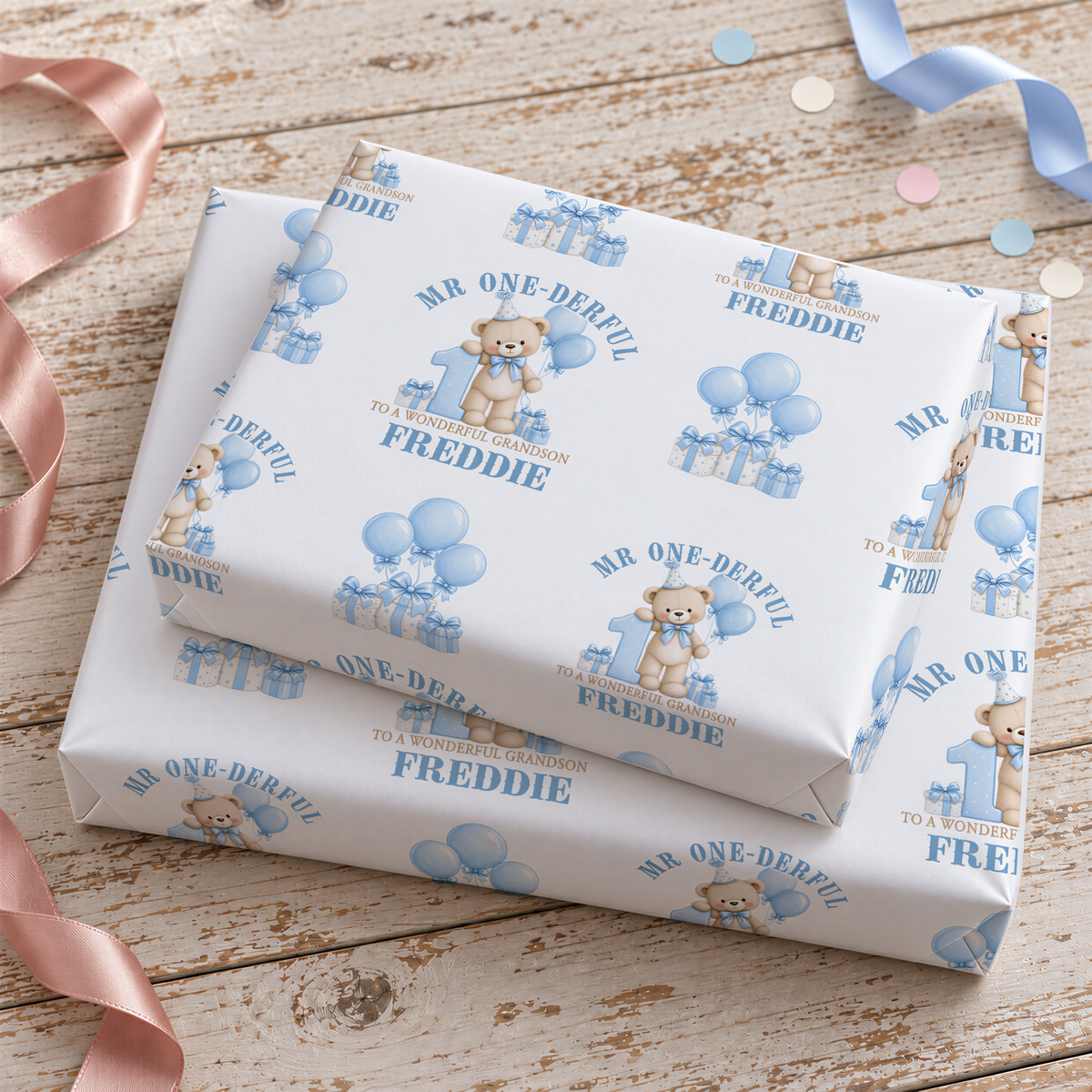 two white gift boxes with blue designs and text, placed on a wooden surface.