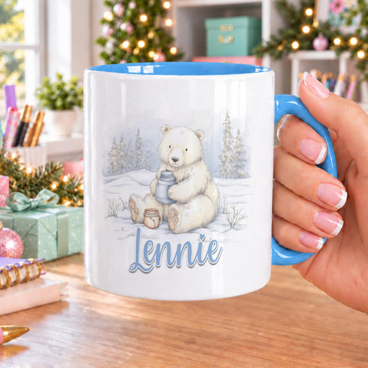 Personalised polar bear mug with blue handle and inside, printed with a watercolour polar bear holding a warm drink in a snowy forest and a name in blue