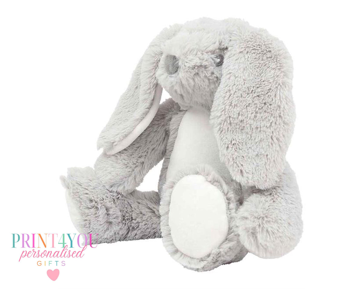 Personalised bunny book cushion styled on a child's bed