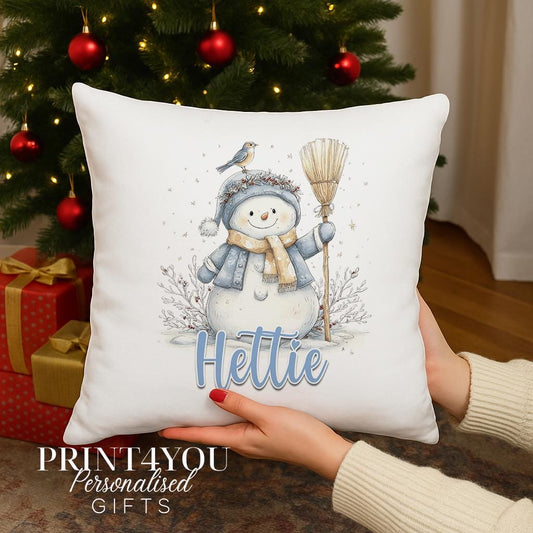 Personalised Christmas cushion with a watercolour snowman in a blue hat and scarf and a robin on top, custom name printed on the front, cushion cover only