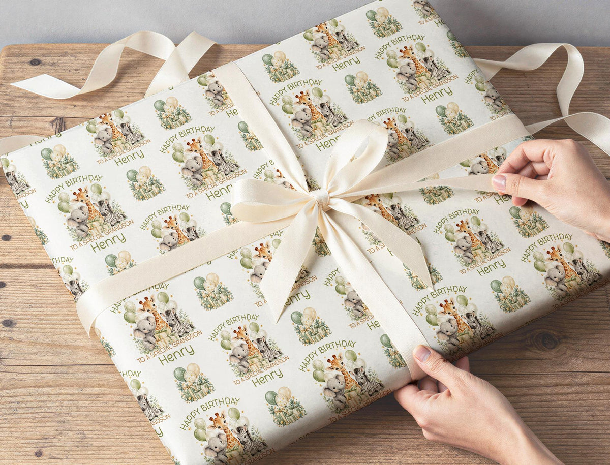 Gift wrapped in personalised sage green safari birthday wrapping paper tied with a cream ribbon