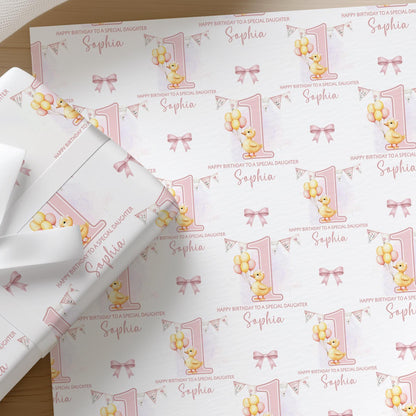 Roll of personalised pink duck wrapping paper with an example name printed on the design