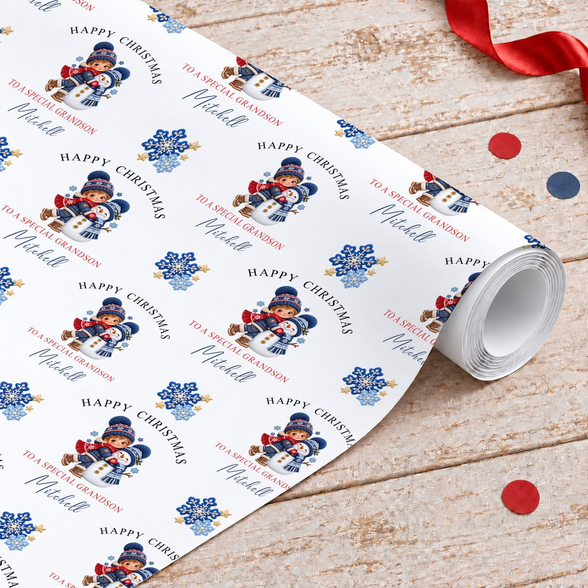 Roll of personalised grandson Christmas wrapping paper with a boy hugging a snowman, blue snowflakes and gold stars