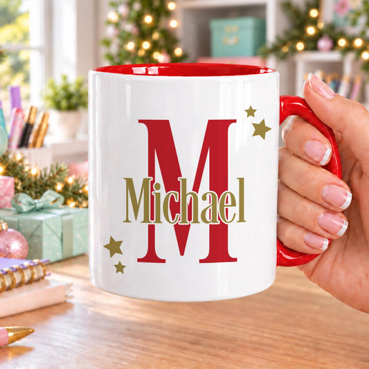 Personalised initial mug with red handle and inside, printed with a large red initial letter and a name in gold across it with little gold stars