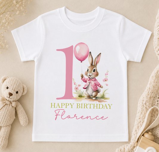 Personalised white t-shirt printed with a pink bunny holding a balloon and 'Happy Birthday Florence'.