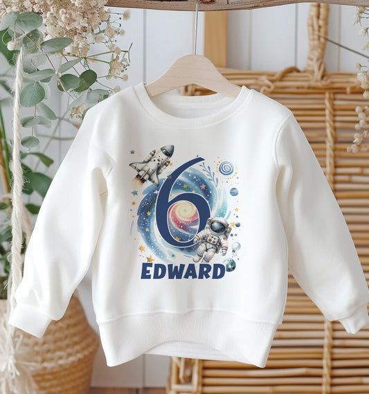 Personalised white cotton sweatshirt with space astronaut design, custom name and birthday age, baby size 6-12 months