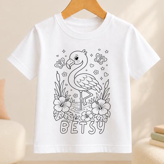 Line-art colour-in design of a flamingo standing on one leg among hibiscus flowers and butterflies, printed on a white kids' t-shirt with a personalised name below