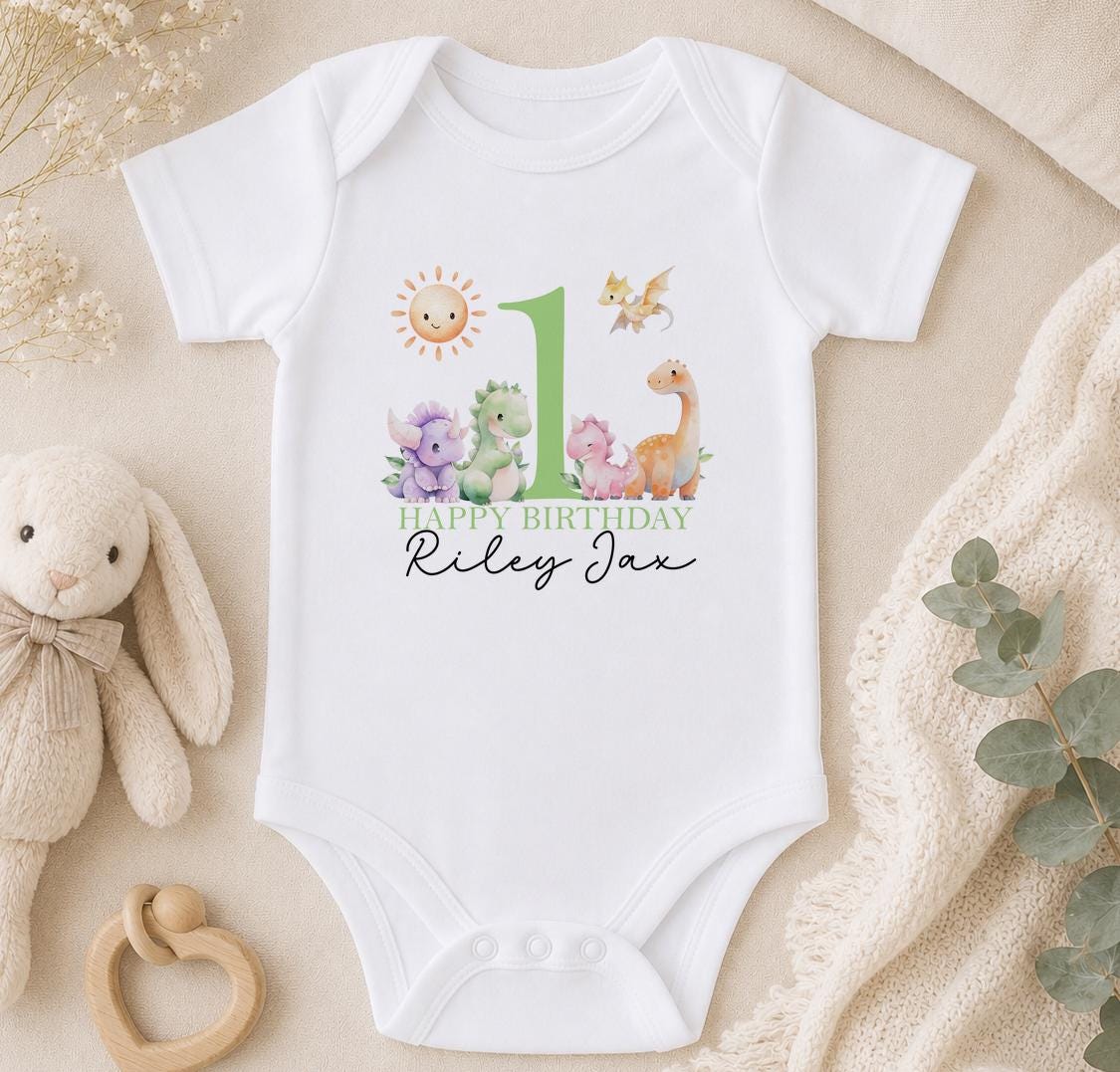Personalised dinosaur first birthday baby vest – pastel dinosaurs around a green number 1 with Happy Birthday Riley Jax
