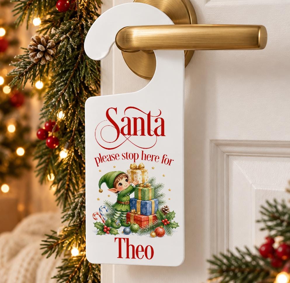 Personalised Santa please stop here door hanger with a Christmas elf and presents and child’s name, hanging on a door handle