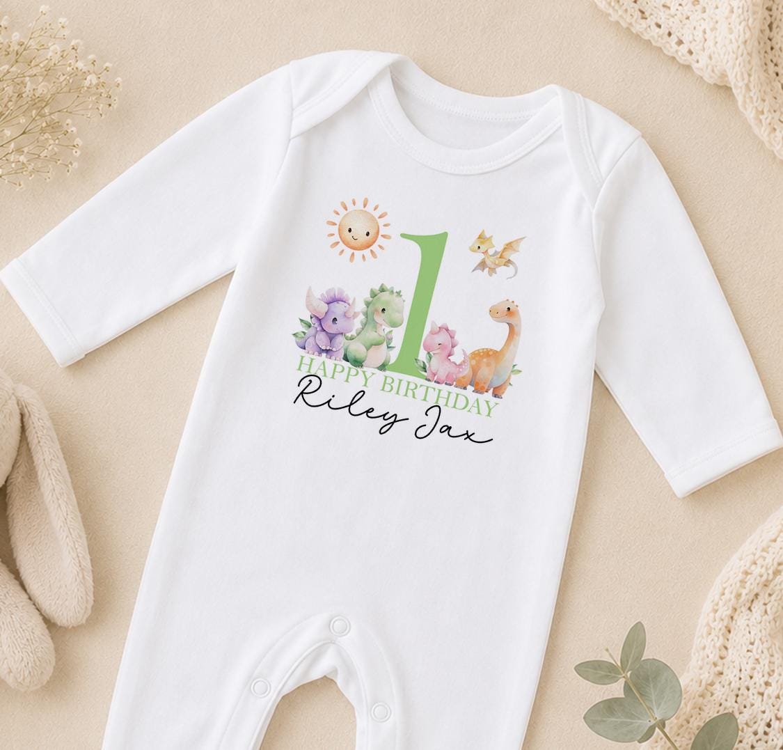 Personalised dinosaur first birthday sleepsuit with Happy Birthday Riley Jax