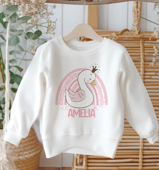 Personalised white cotton sweatshirt with pink rainbow swan design and custom name, baby size 6-12 months