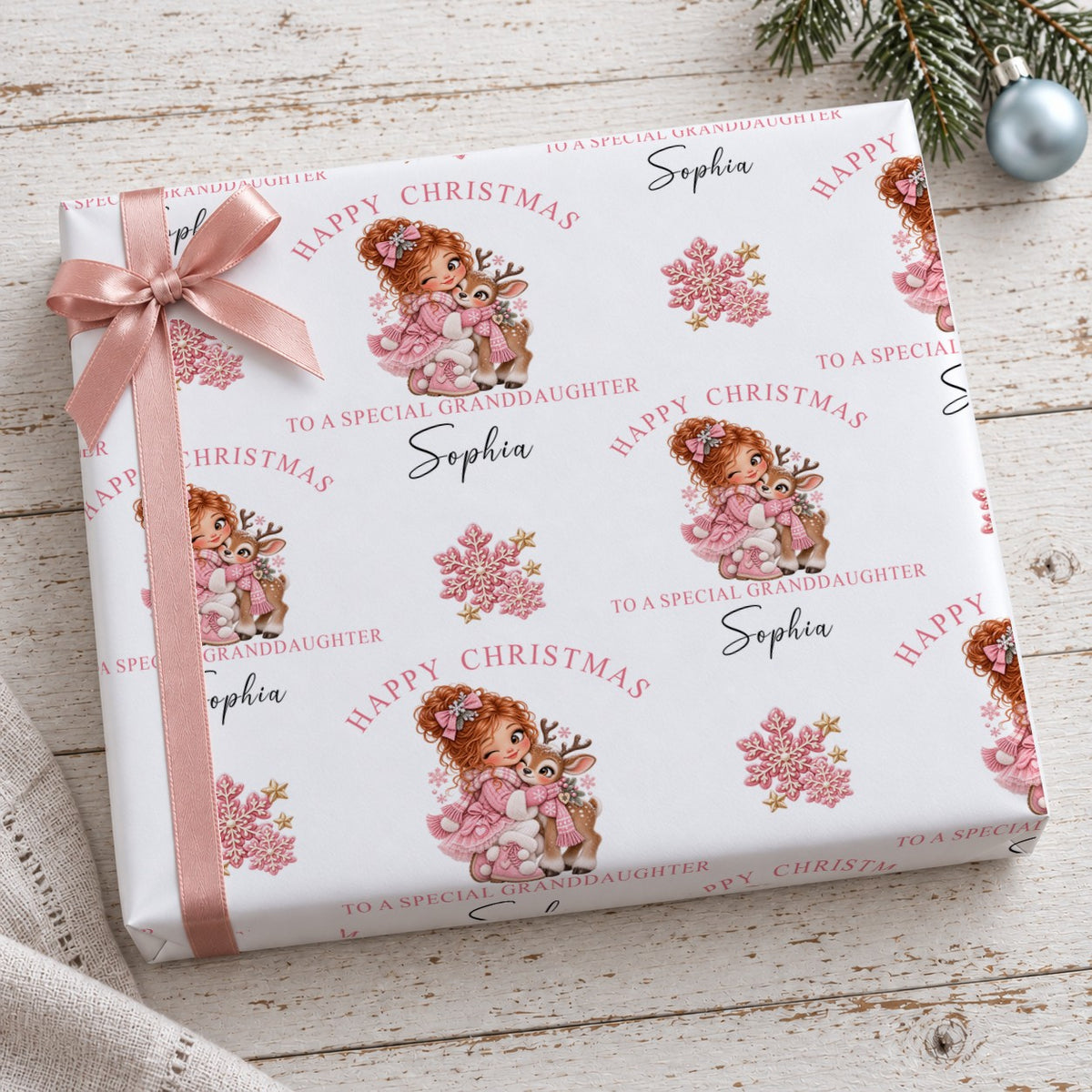 Present wrapped in personalised Happy Christmas To A Special Granddaughter reindeer wrapping paper with a pink bow