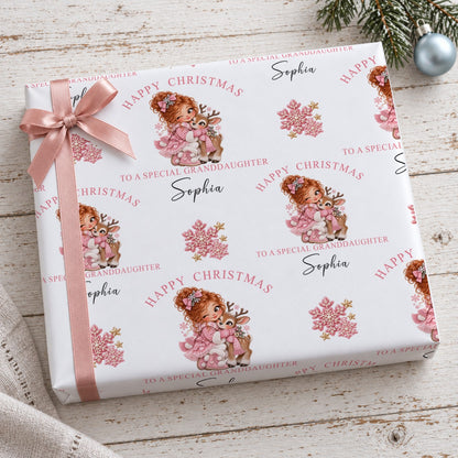 Present wrapped in personalised Happy Christmas To A Special Granddaughter reindeer wrapping paper with a pink bow