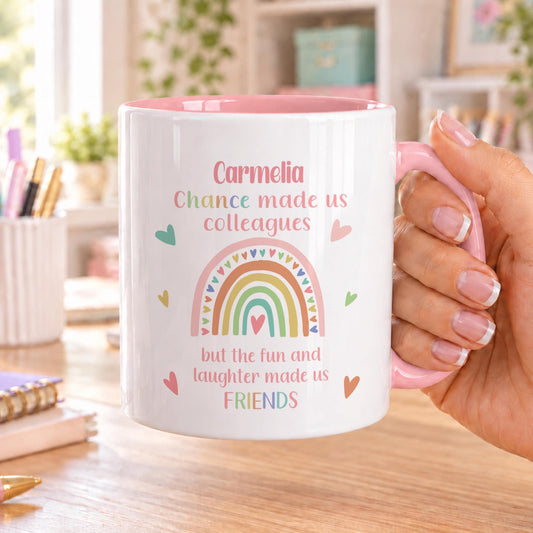 Personalised colleague mug with pink handle and inside, printed with a name, a pastel rainbow and Chance made us colleagues but the fun and laughter made us friends