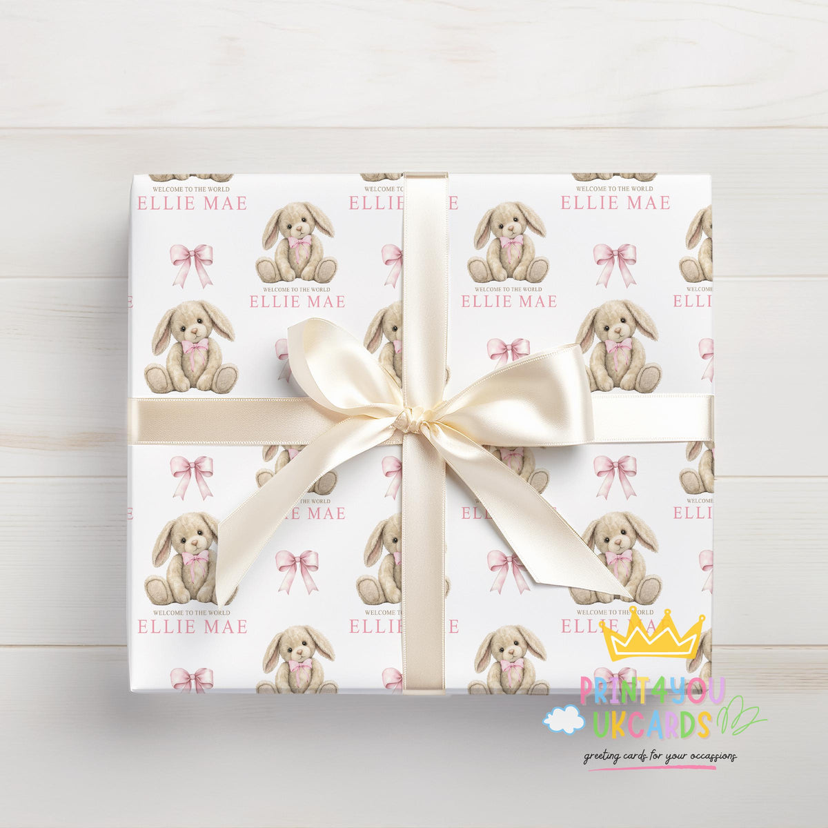 Personalised newborn wrapping paper sheet laid flat showing the full pink bunny and teddy repeat pattern