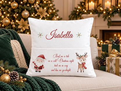 Personalised white Christmas book pocket cushion with Santa and a reindeer either side of a rhyme, child’s name in red, on a festive sofa
