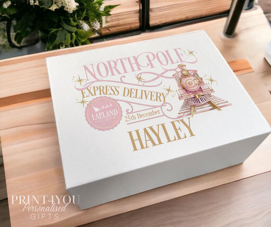 White Christmas keepsake box in the medium 16x20x8cm size, printed with a blush pink and gold North Pole Express train design, Lapland stamp and the name Hayley