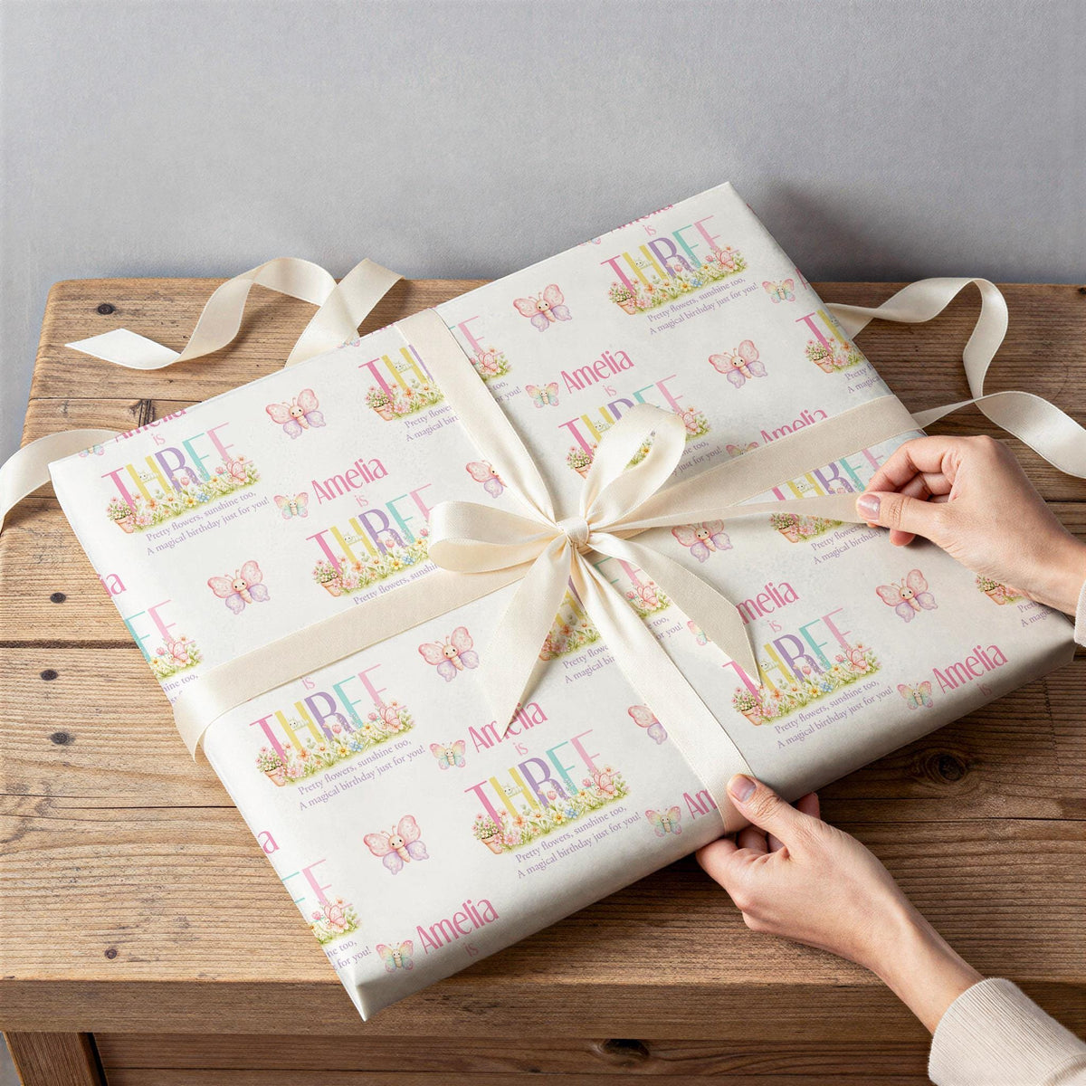 Close-up of the butterfly garden wrapping paper pattern with personalised name and age