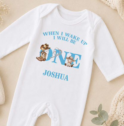 A white onesie with a personalized text and illustrations printed on it.