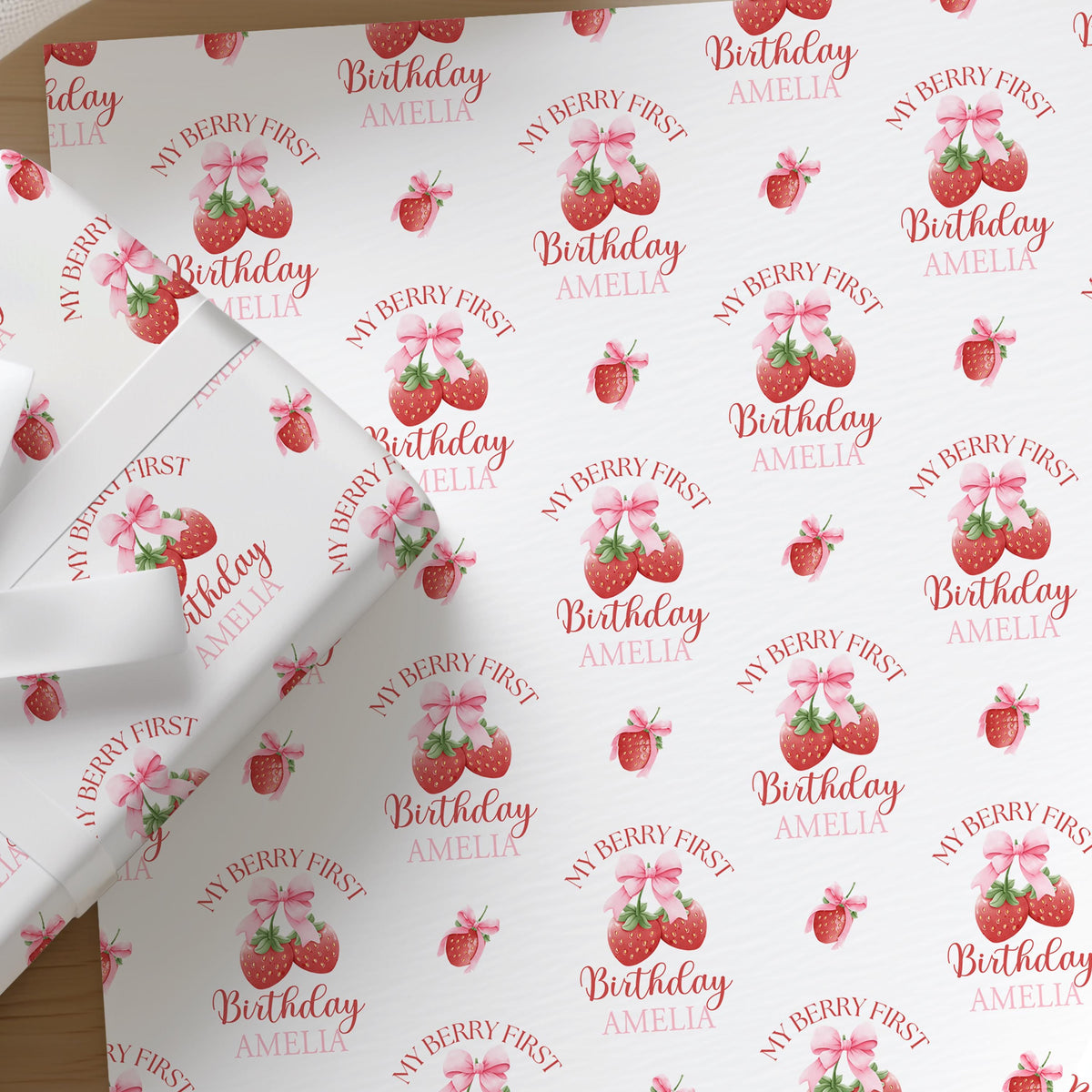 Personalised strawberry wrapping paper printed with a custom name, shown as a full sheet