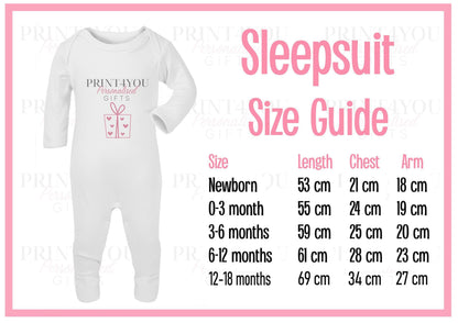 Personalised blue safari sleepsuit styled for a first birthday photo shoot