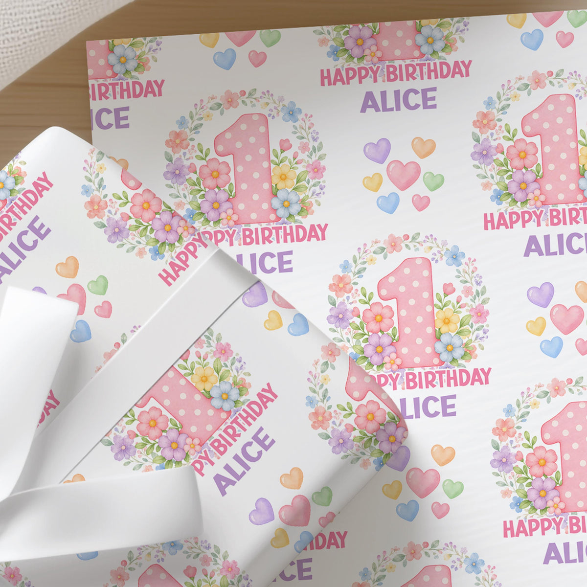 Personalised blossom number wrapping paper sheet laid flat showing the full repeating floral number pattern with name.
