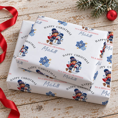 Stacked gifts wrapped in personalised boy and snowman Christmas wrapping paper printed with the name Mitchell