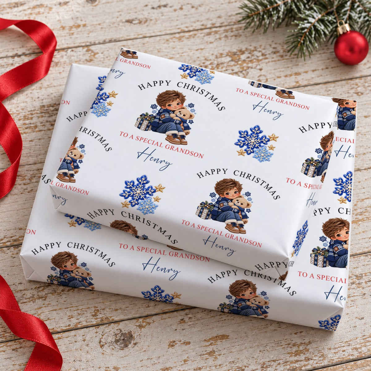 Stacked gifts wrapped in personalised boy and teddy Christmas wrapping paper printed with the name Henry