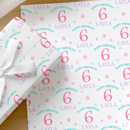 Personalised pastel stars birthday wrapping paper with custom name and age, colourful star pattern for a girl's birthday.