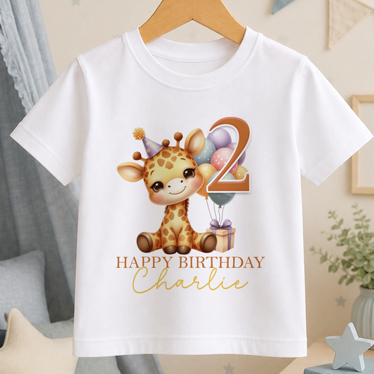 White cotton birthday t-shirt printed with a giraffe holding balloons and a gift box, personalised with a child's name and age
