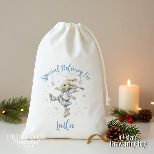 Personalised bunny Christmas sack, white A3 drawstring gift bag printed with a bunny in a blue scarf in the snow and Special Delivery For a name