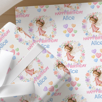 Personalised fairy wrapping paper shown wrapped around a gift box to demonstrate the finished look.