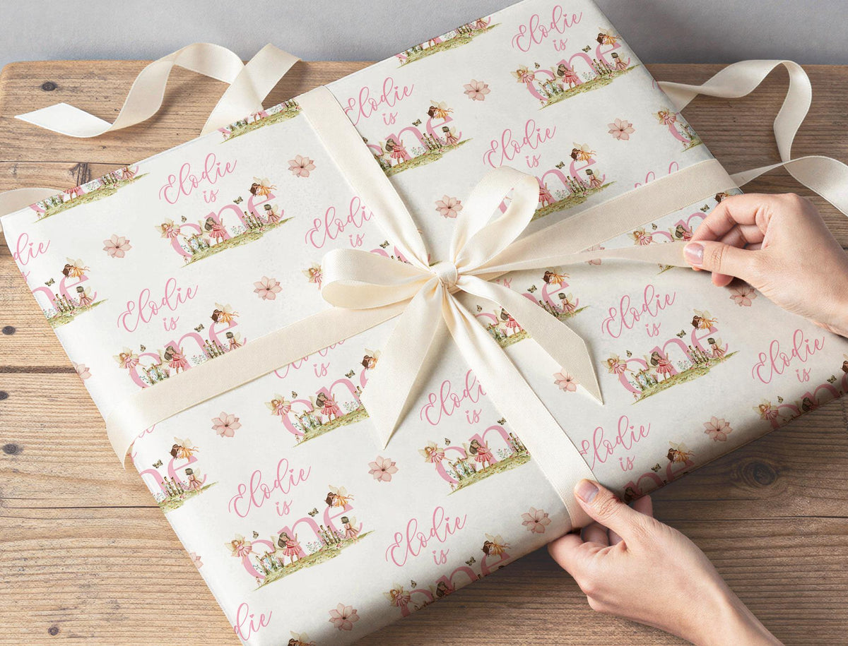 Personalised fairy wrapping paper rolled and shown against a plain background