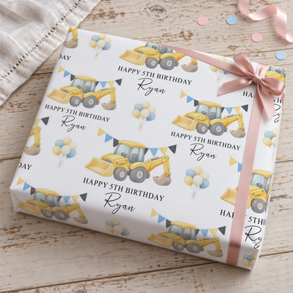 The image is a birthday gift wrapped with a pattern featuring a yellow construction vehicle and balloons, along with the text "Happy 5th Birthday Ryan".