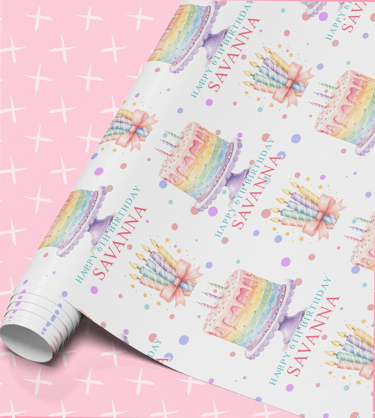 Birthday wrapping paper printed with pastel rainbow layer cakes, bundles of striped candles and confetti dots, with Happy 6th Birthday and the name Savanna on a white background, shown part unrolled