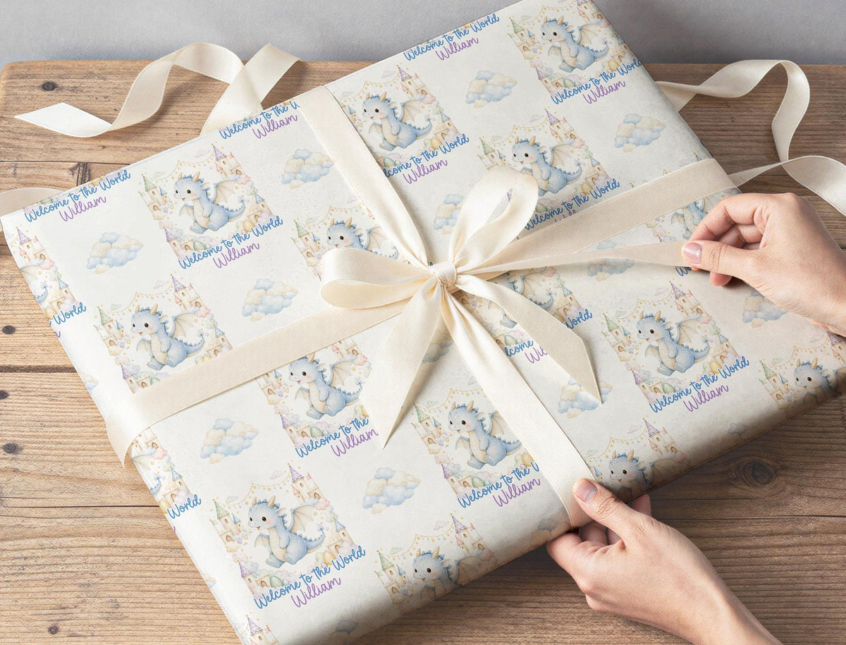 Gift wrapped in the personalised blue dragon baby wrapping paper, finished with ribbon