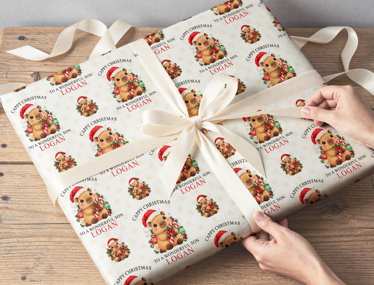 Gift wrapped in personalised Cappy Christmas candy cane wrapping paper tied with a cream ribbon