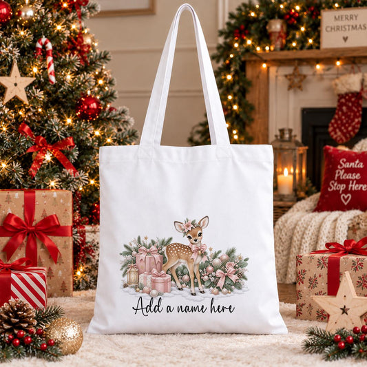 White cotton tote bag printed with a watercolour fawn wearing a pink flower crown among blush presents, above a personalised name