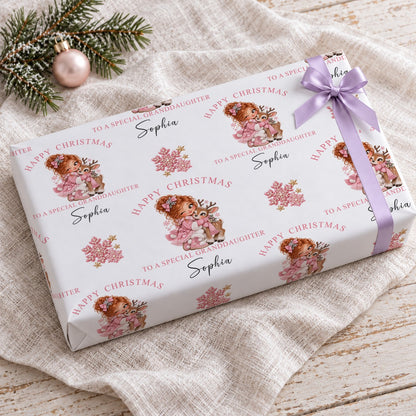 Gift wrapped in personalised granddaughter reindeer Christmas wrapping paper with a lilac bow on a linen cloth