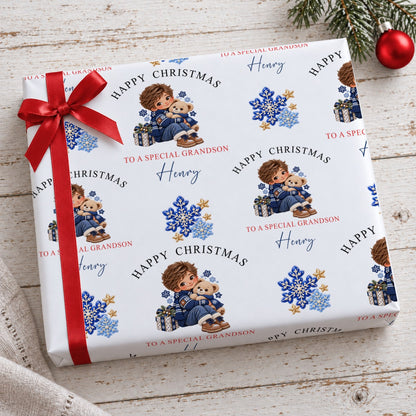 Present wrapped in personalised Happy Christmas To A Special Grandson wrapping paper with a red bow