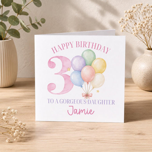 Square personalised birthday card featuring pastel balloons, with space for a girl's printed name and age