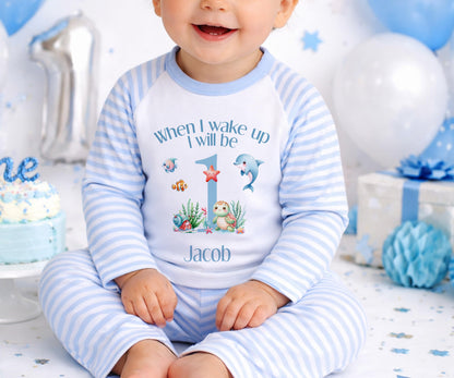 Personalised under the sea first birthday outfit with turtle, dolphin, starfish and coral design and custom name.
