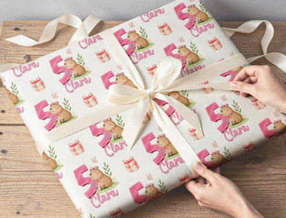 Personalised capybara birthday wrap rolled and shown with a tape measure to indicate width.