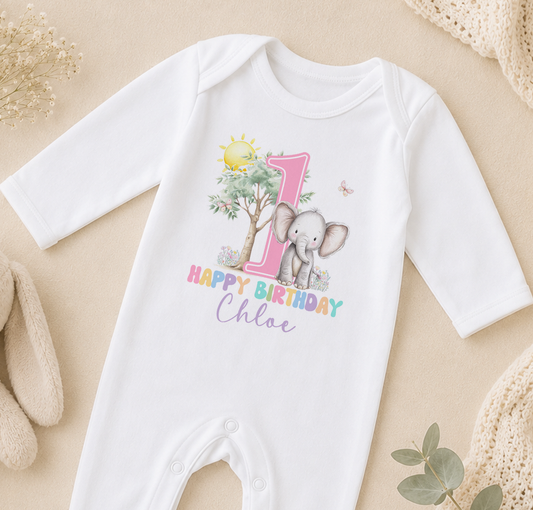A white onesie with a printed image of an elephant and the text "Happy Birthday Chloe" printed on it.