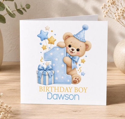 Personalised teddy 1st birthday card – teddy in a party hat peeping round a blue number 1, Birthday Boy Dawson