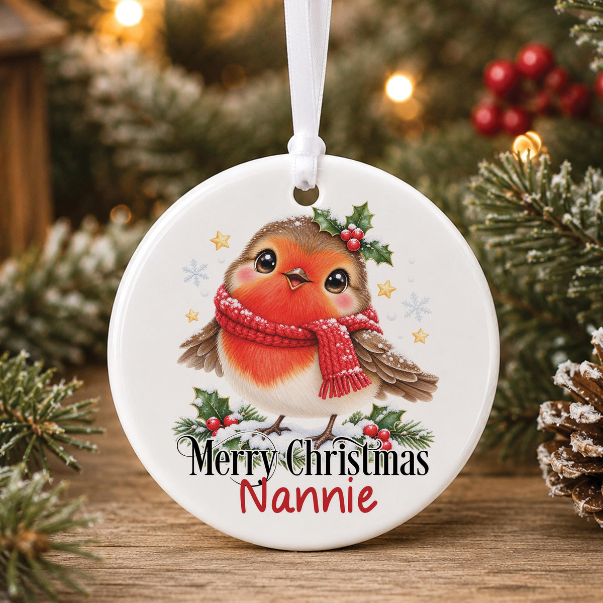 Personalised white ceramic Christmas bauble with a robin in a red scarf among holly, “Merry Christmas” and a name
